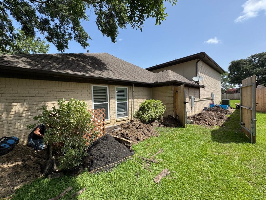 Exterior holes for perimeter pilings along the outside of a Pearland foundation repair job